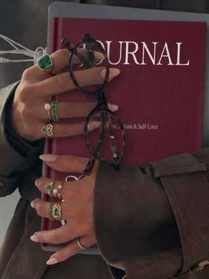 Aesthetic hands with rings holding the Ellafits Premium Editorial Journal made for woman all in one -- Guided Journaling aesthetic. Daily Plan, weekly plan, gratitude and Self love plan